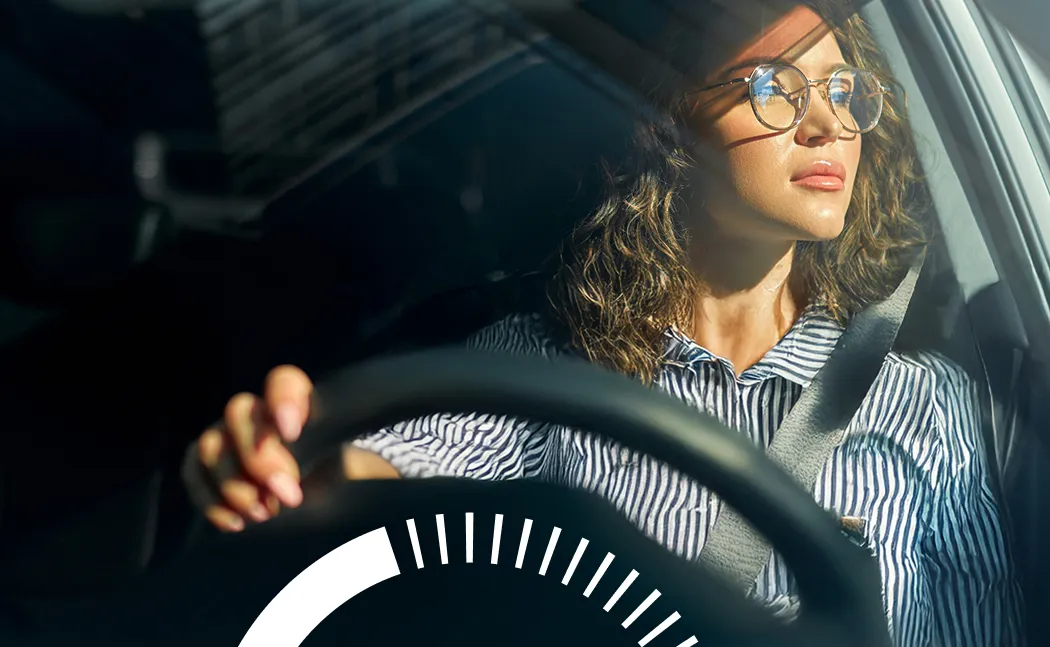 A woman driving and looking out the window