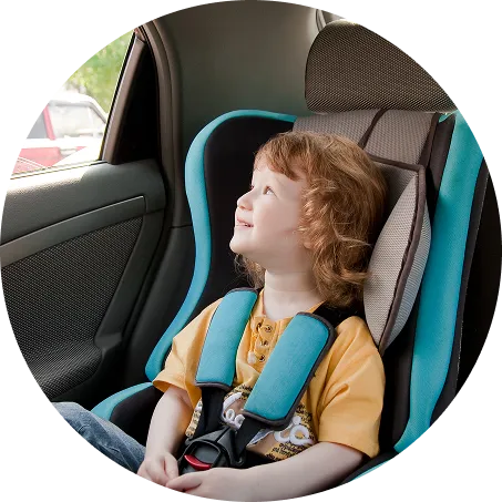 A child in a car seat looking out the car window